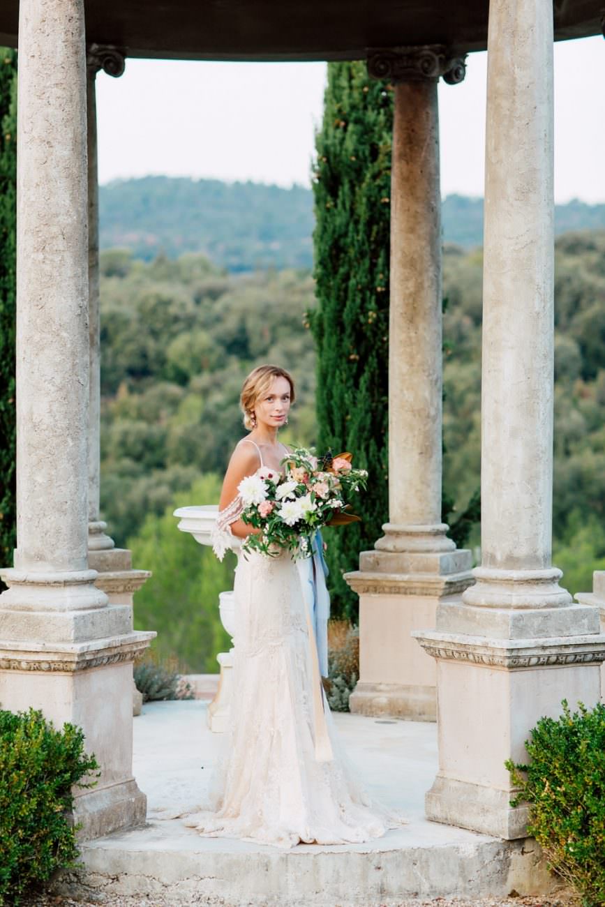 French Wedding Inspiration Bride with bouquet under gazzebo