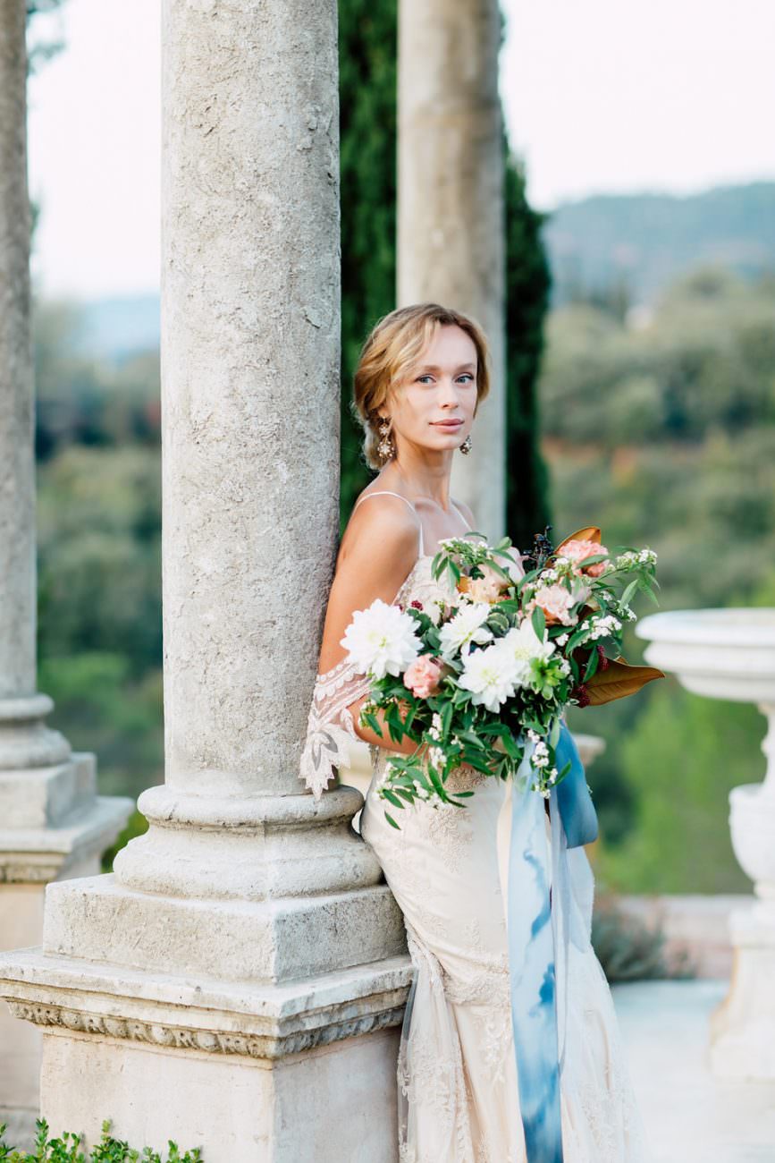 French Wedding Inspiration bride leaning against column