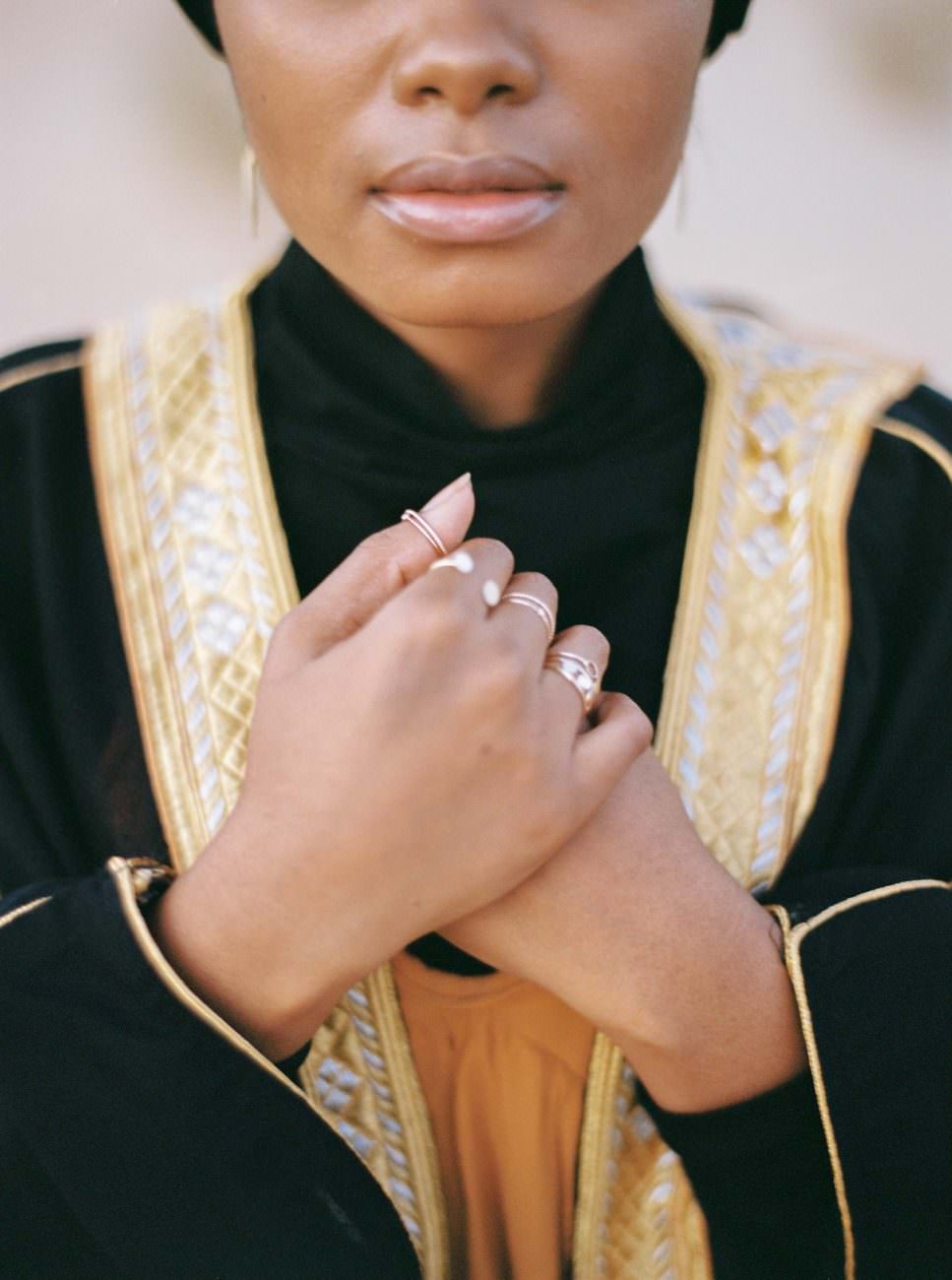 Desert fine art wedding inspiration bride with black robe with gold border