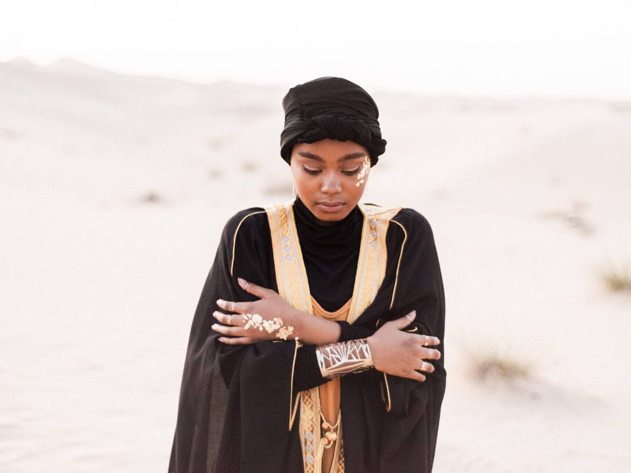 Desert fine art wedding inspiration bride with gold bracelet in desert