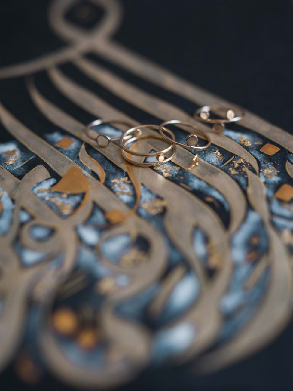 Desert fine art wedding inspiration gold Arabic calligraphy art with rings