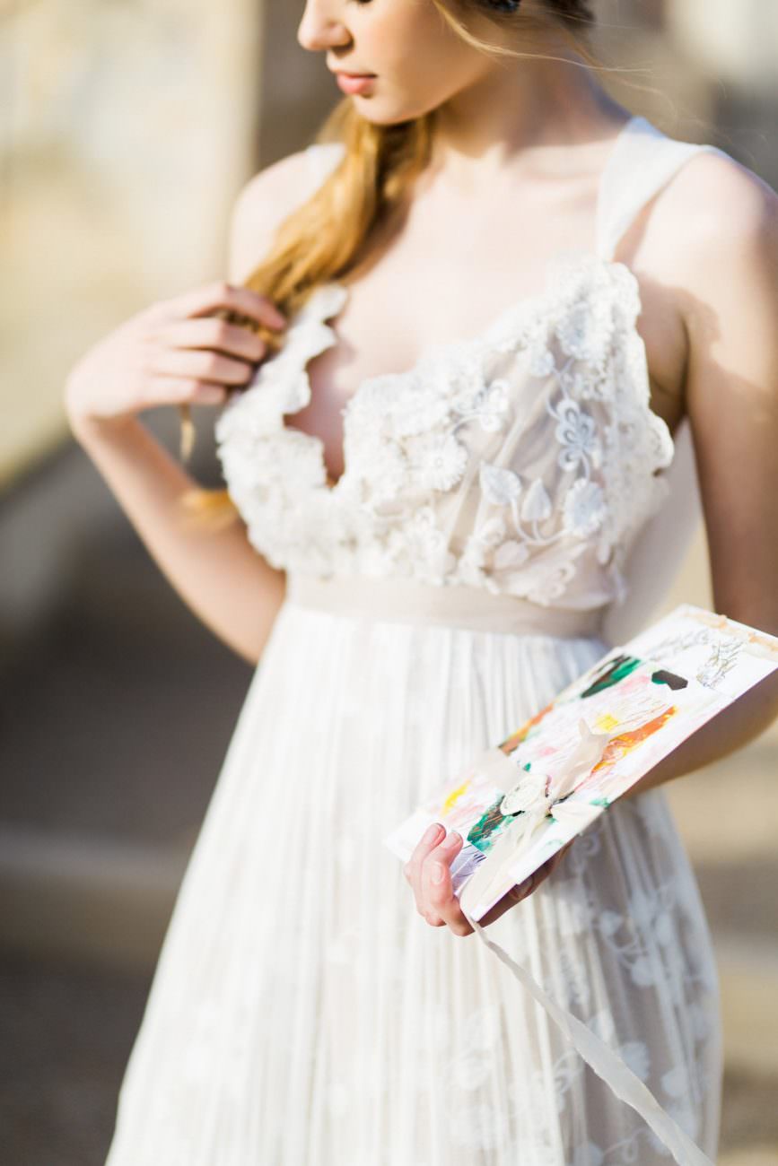Palace Wedding Inspiration bride holding artwork