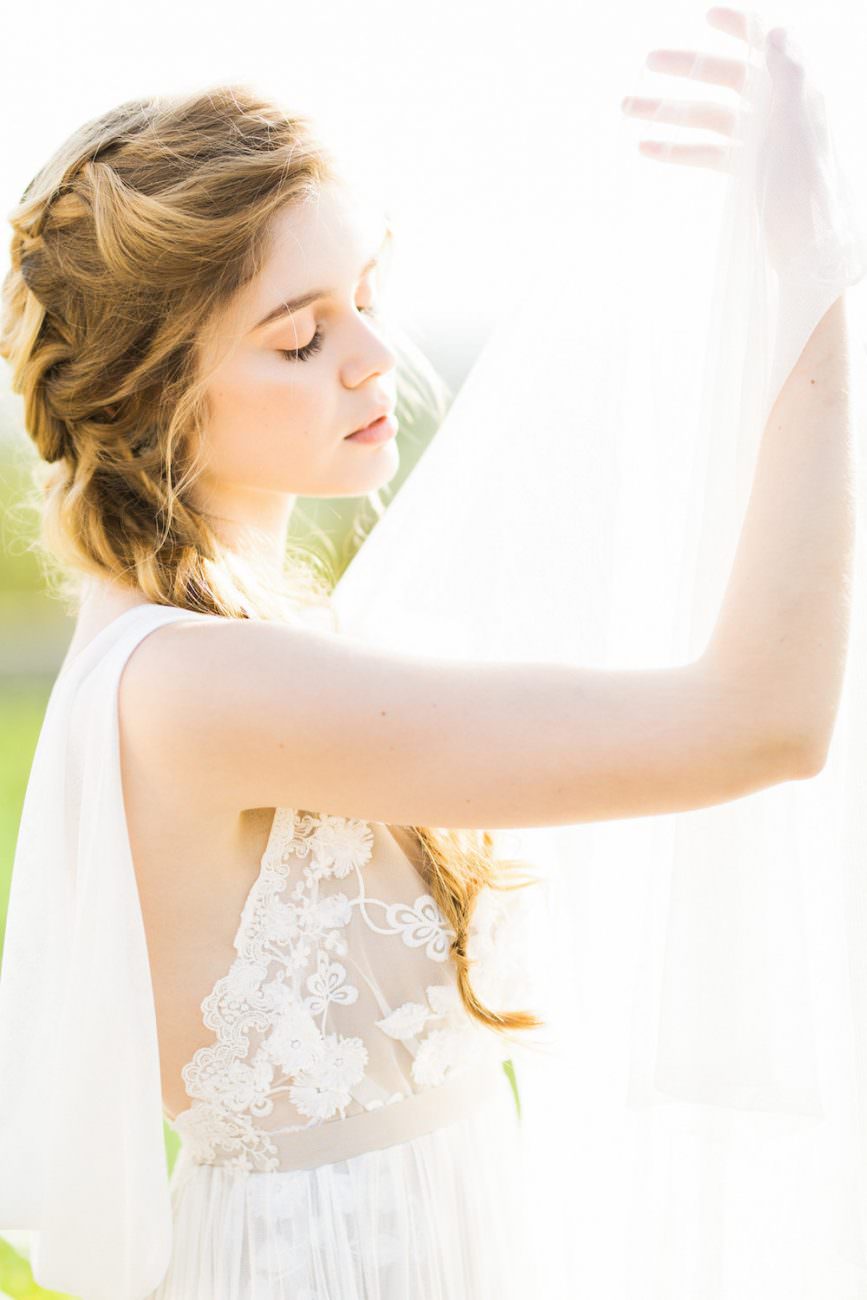 Palace Wedding Inspiration bride in sunlight with veil