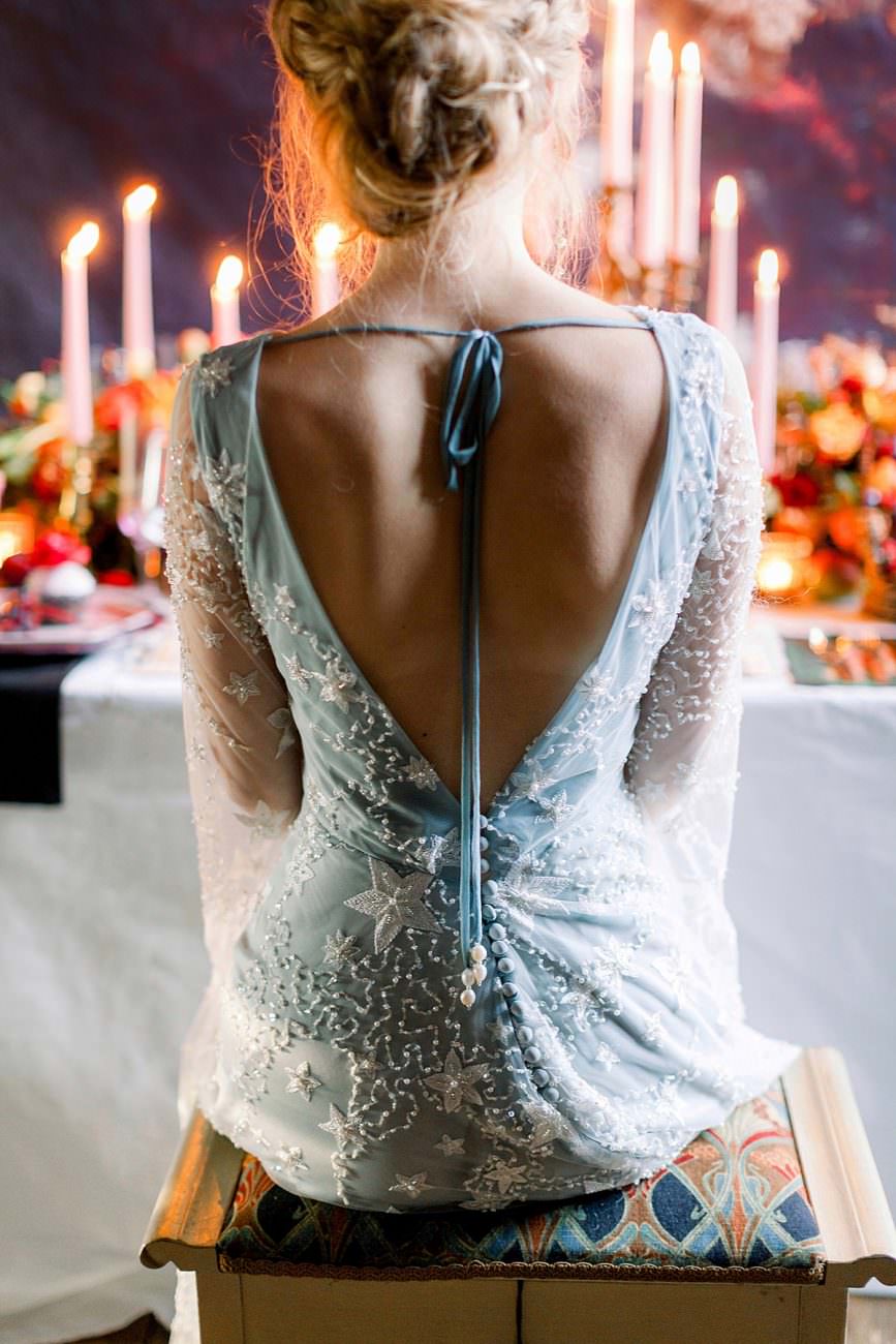 Baroque wedding with a bride in a low cut white dress with stars and beading