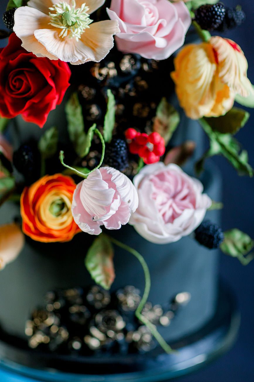 Baroque Wedding cake with large yellow pink and red sugar flowers