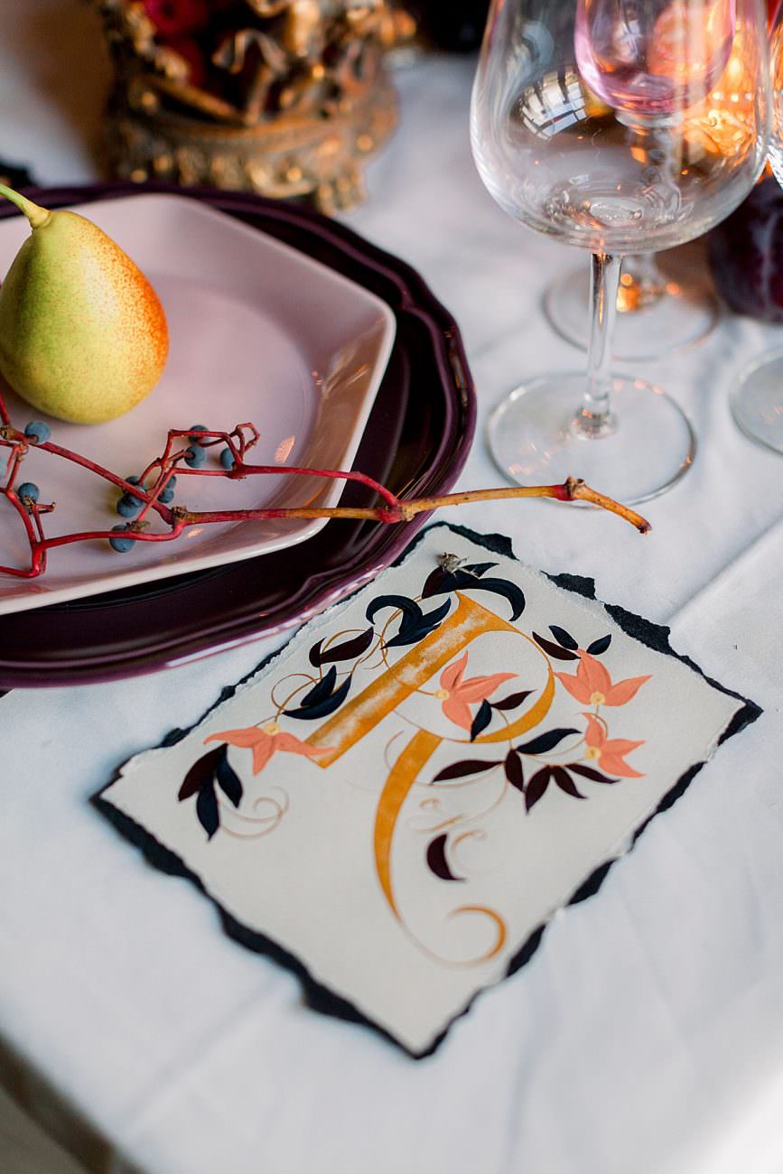 Baroque wedding inspiration with a large sized place name with black hand painted leaves