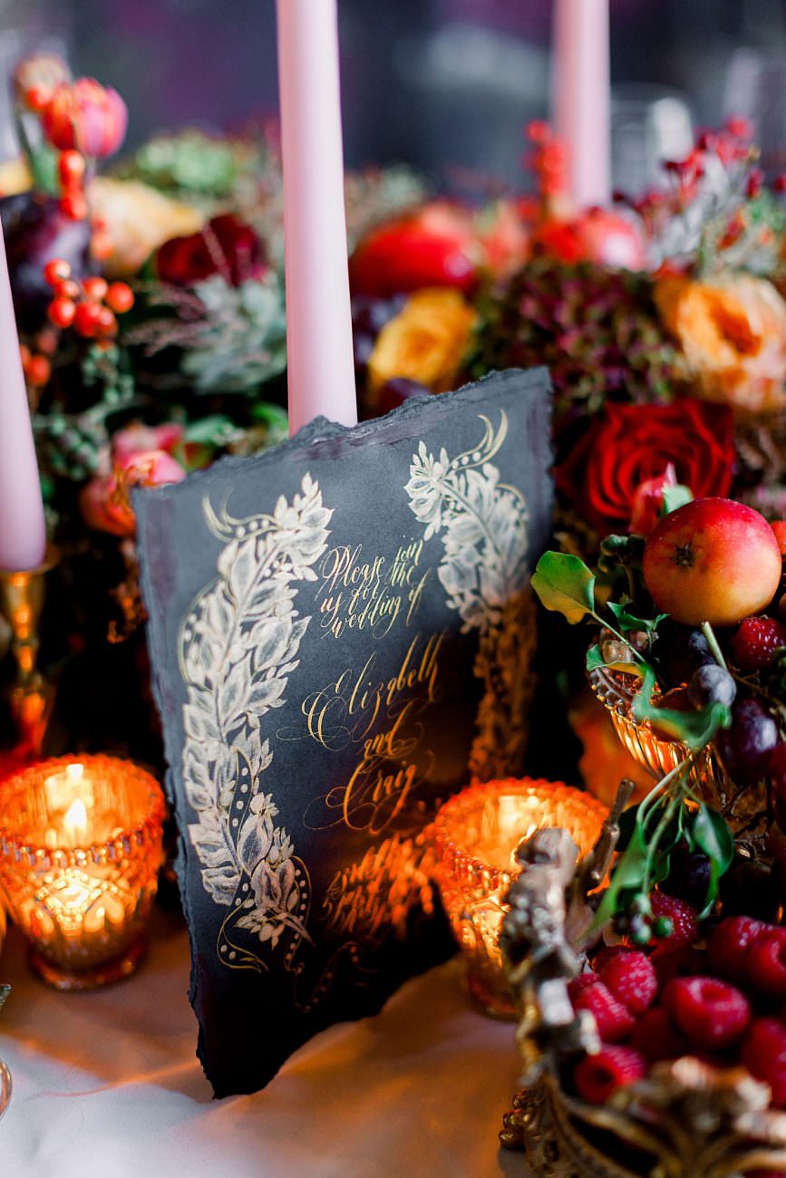 Baroque wedding inspiration with black wedding invite styled next to candles