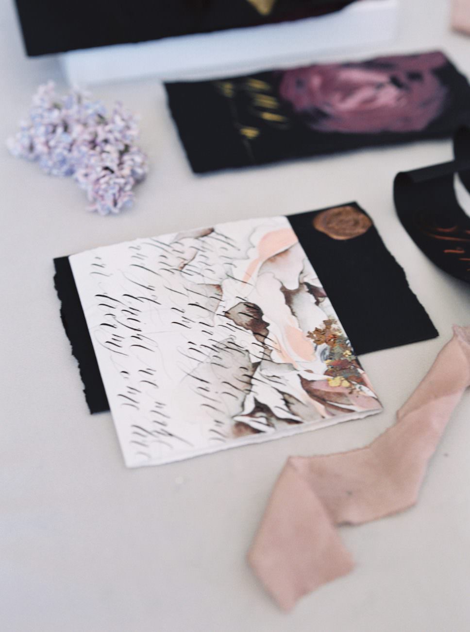 Wedding invitation wrap with light floral accents and black calligraphy