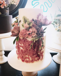 luxury wedding cake designers white cake with little pink blossoms