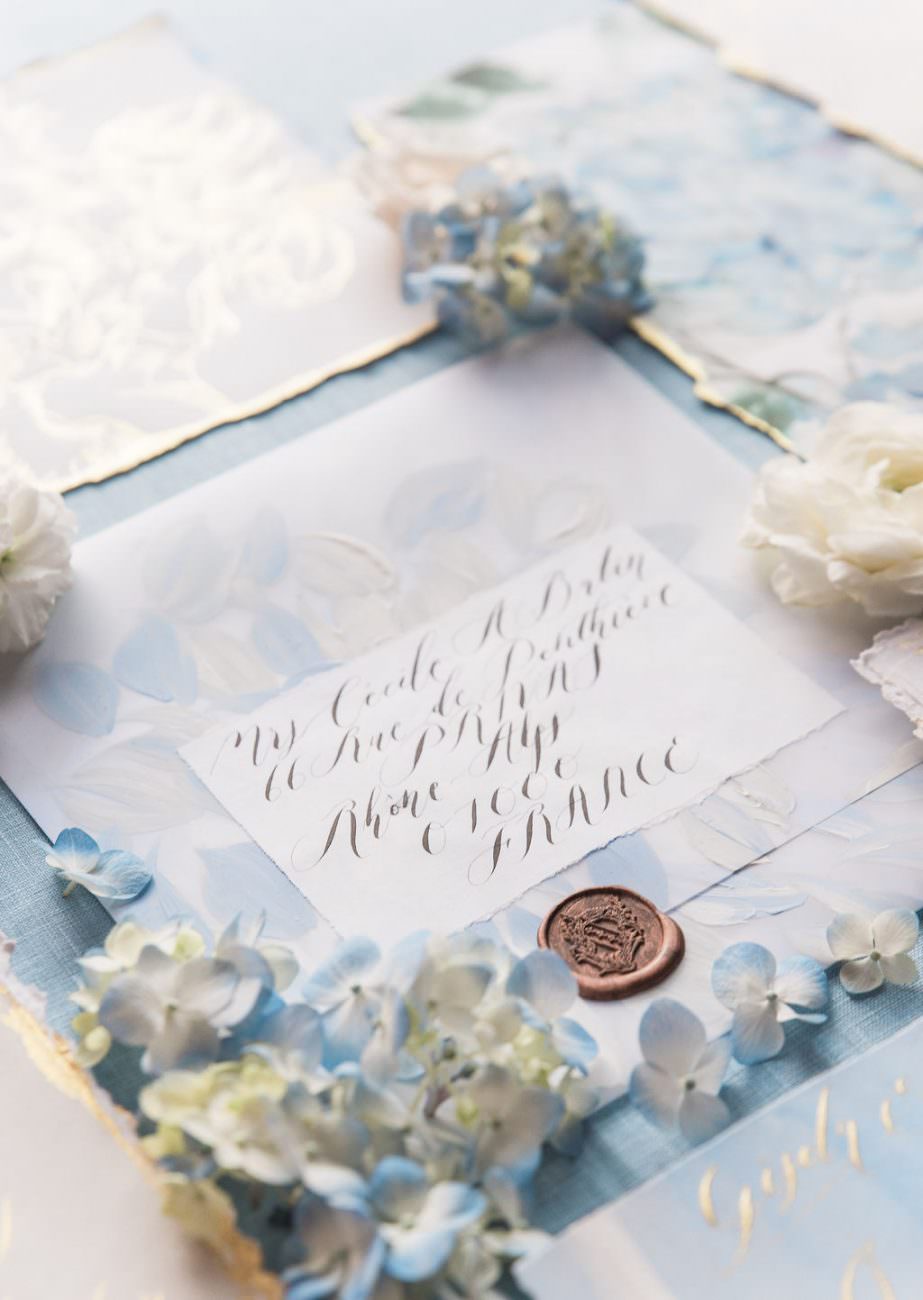 Large white vellum envelope, hand pianted with pale blue and white floral design