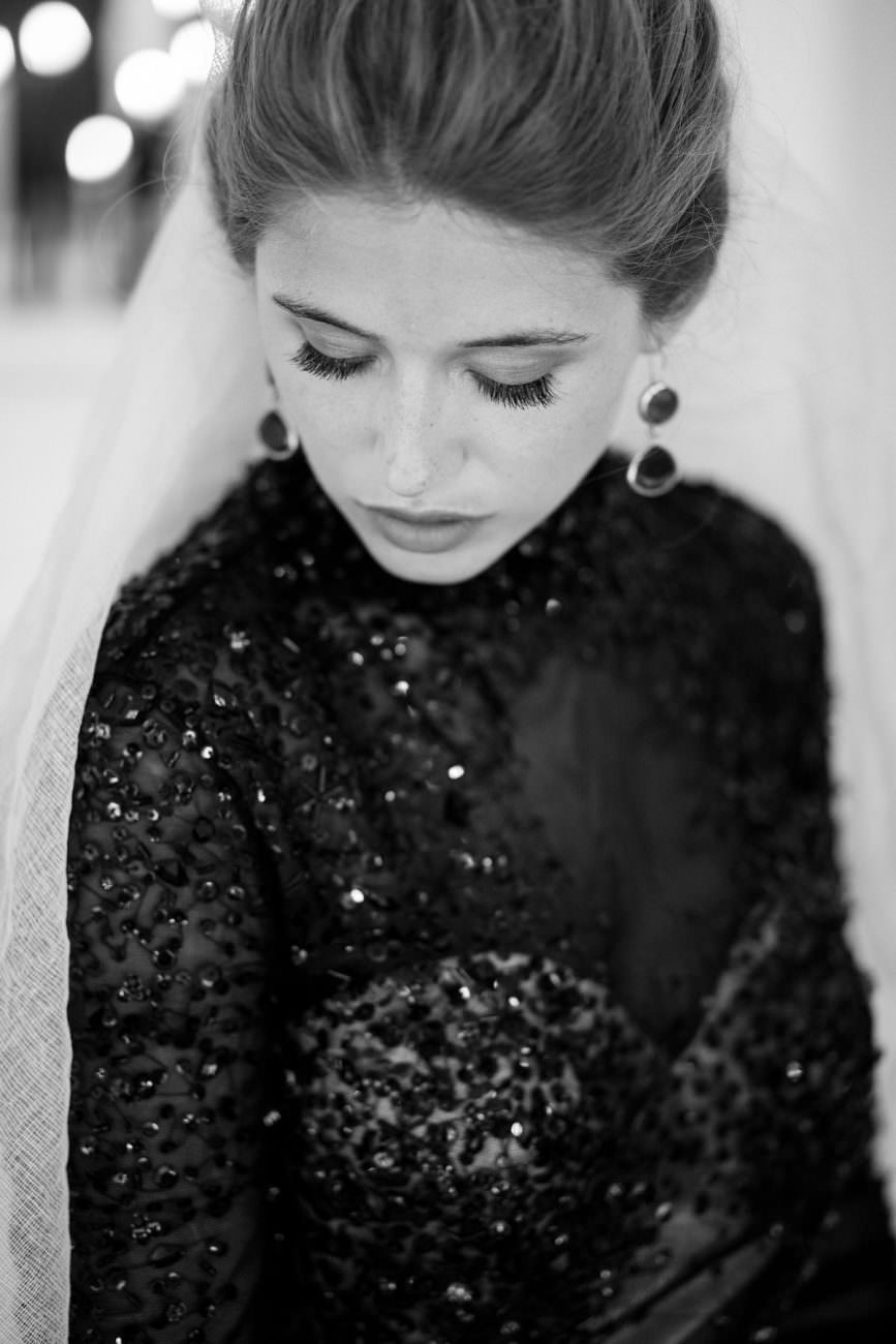 Fine Art Black Tie Wedding Inspiration Shoot Bride looking down with earrings