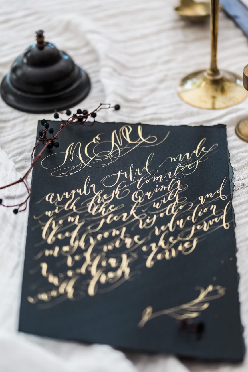 Fine Art Black Tie Wedding Inspiration Shoot black wedding menu with gold calligraphy
