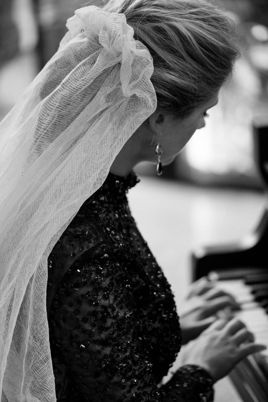 Fine Art Black Tie Wedding Inspiration Shoot bride on piano with gathered veil