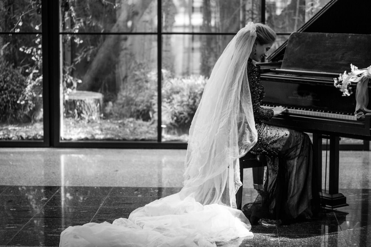 Fine Art Black Tie Wedding Inspiration Shoot bride on piano with veil