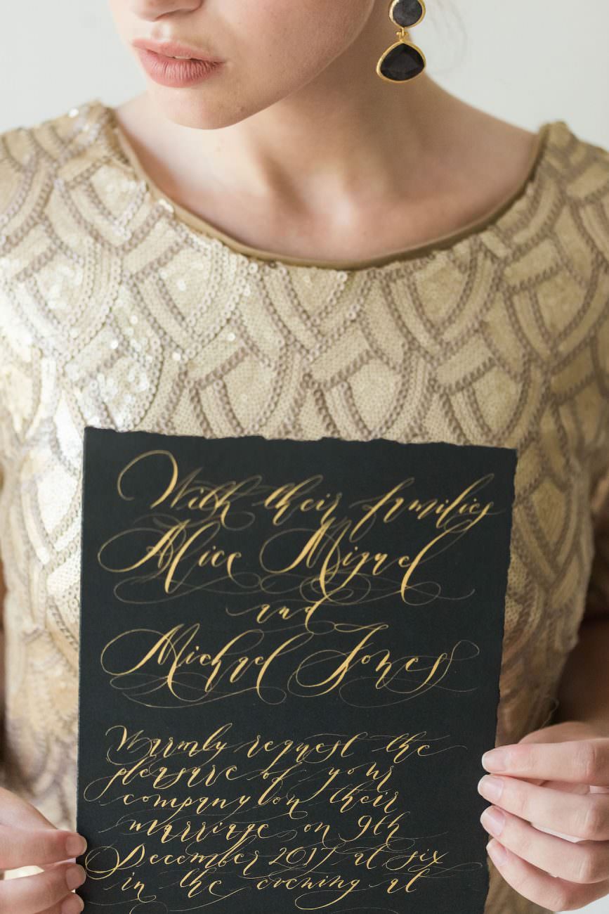 Fine Art Black Tie Wedding Inspiration Shoot bride with black card and gold calligraphy