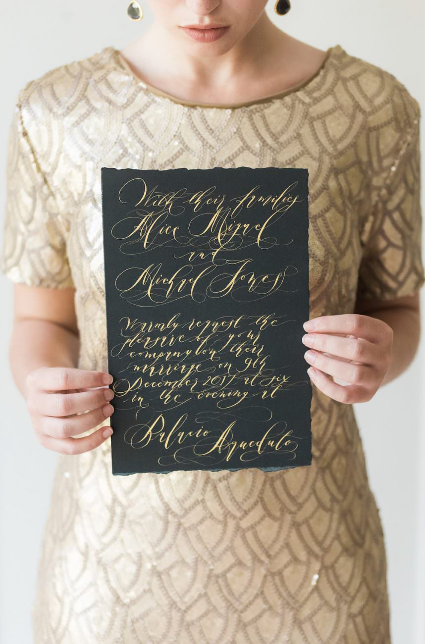 Fine Art Black Tie Wedding Inspiration Shoot bride with gold dress and black invitation