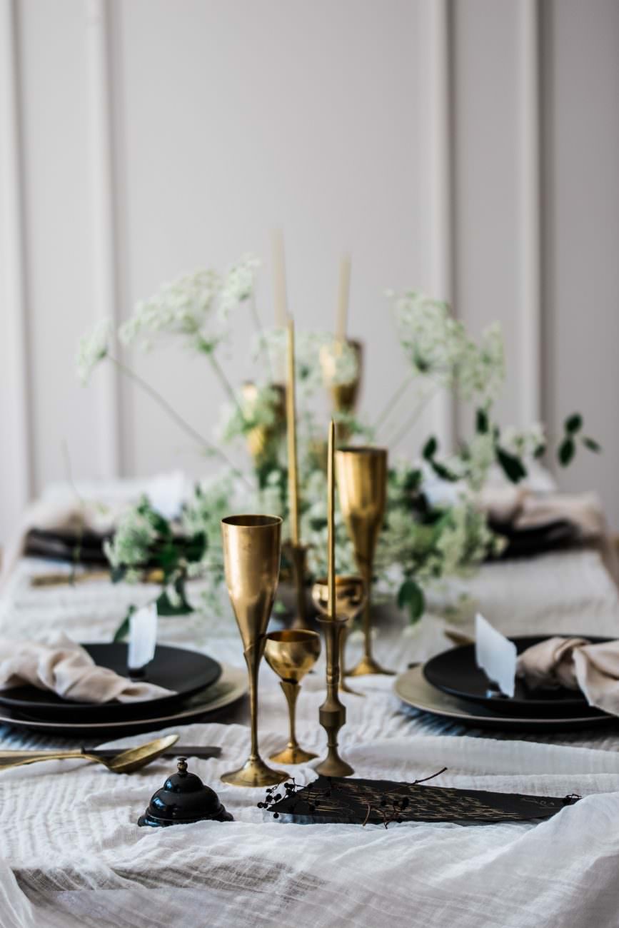Fine Art Black Tie Wedding Inspiration Shoot table setting with gold glasses and menus