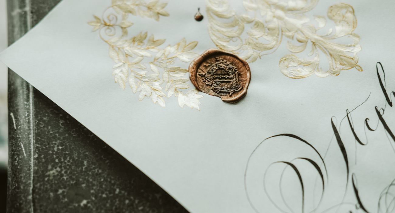 Invitation Glossary black calligraphy flourishes with gold painting and wax seal