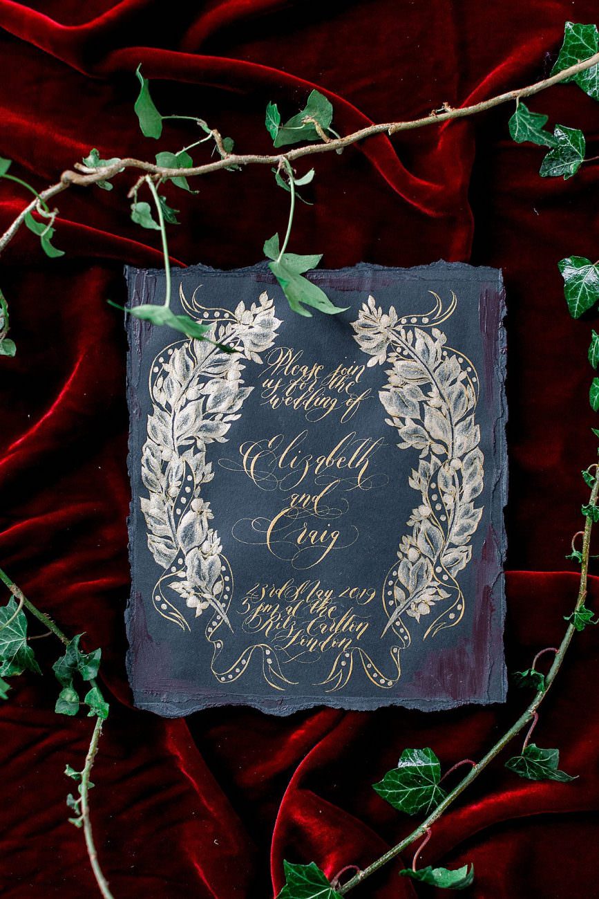 Baroque Wedding black invitation with a symmetrical gold wreath