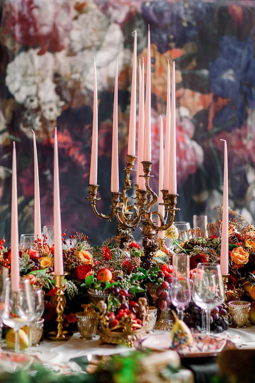 Baroque wedding picture of candles on a table with flowers