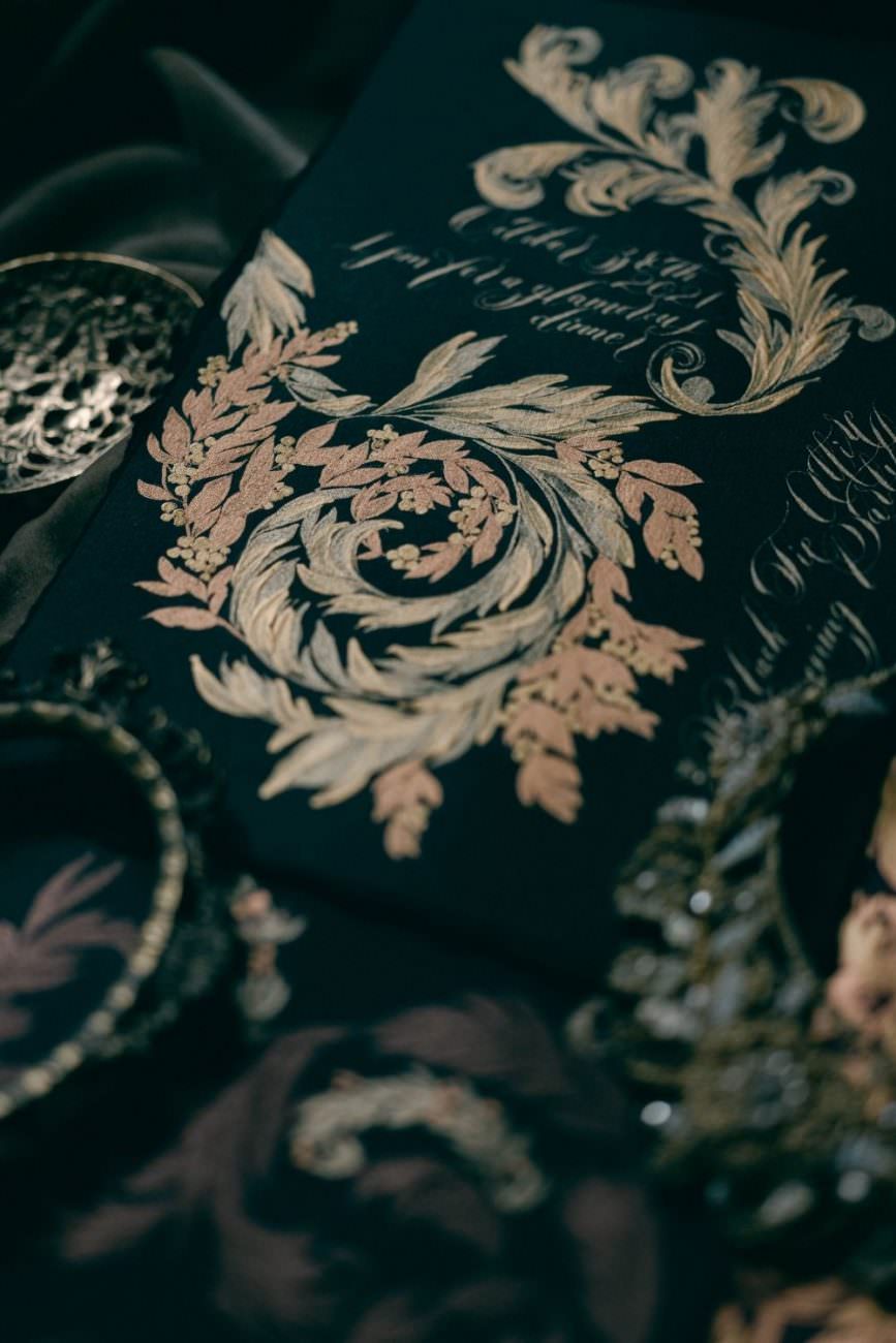 Dark and moody, yet chic and refined, gold and copper combine with black for a classical wedding invitations suite inspired by Renaissance