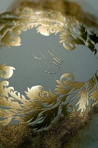 Luxury tarnished gold foil printed wedding crest with calligraphy initials for a custom design wedding stationery suite